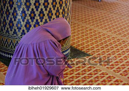 Stock Photo - Praying woman, National Mosque, Kuala Lumpur, Malaysia, Southeast Asia, Asia. Fotosearch