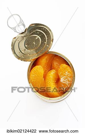 Stock Image - Preserved food, opened tin of mandarin pieces. Fotosearch