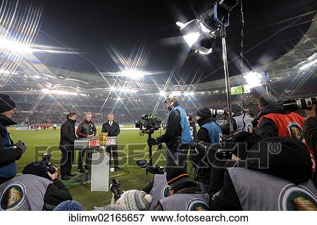 Stock Photo - Press photographers, TV cameras, sports photographers, DFB trophy in front of Jupp Heynckes, coach of FC Bayern Muenchen, Bruno Labbadia, coach of VfB Stuttgart, and far left, a Sky Sports presenter, Mercedes-Benz Arena, Stuttgart, Baden-Wuerttemberg,.... Fotosearch