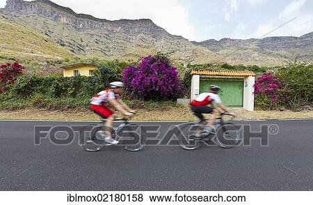 Racing cyclists in the mountains around Barranco de Guayadeque, Gran Canaria, Canary Islands, Spain, Europe View Large Photo Image Stock Photo - Racing cyclists in the mountains around Barranco de Guayadeque, Gran Canaria, Canary Islands, Spain, Europe. Fotosearch