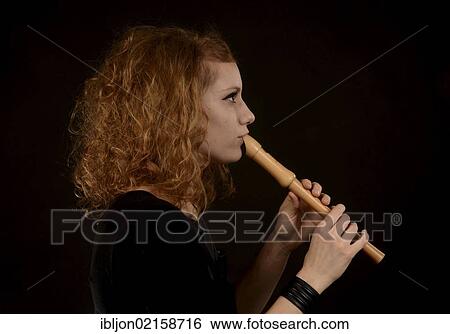 Red-haired woman playing the recorder View Large Photo Image Stock Photograph - Red-haired woman playing the recorder. Fotosearch
