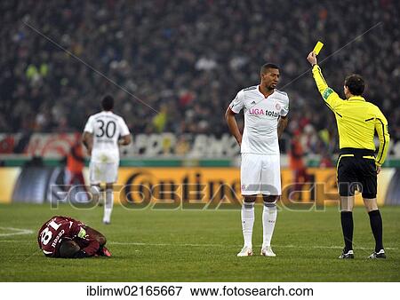Referee Florian Meyer showing Jerome Boateng, FC Bayern Muenchen, a yellow card for a foul on Cacau, VfB Stuttgart, left, lying on the ground, Mercedes-Benz Arena, Stuttgart, Baden-Wuerttemberg, Germany, Europe View Large Photo Image Stock Photo - Referee Florian Meyer showing Jerome Boateng, FC Bayern Muenchen, a yellow card for a foul on Cacau, VfB Stuttgart, left, lying on the ground, Mercedes-Benz Arena, Stuttgart, Baden-Wuerttemberg, Germany, Europe. Fotosearch