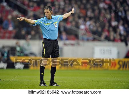 Stock Image - Referee Wolfgang Stark showing foul play, awarding a free kick, Mercedes-Benz Arena, Stuttgart, Baden-Wuerttemberg, Germany, Europe. Fotosearch