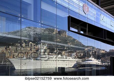 Reflection on the facade of the cruise terminal of Port Hercule with motor yachts, Atlantis II and The One, Principality of Monaco, Côte d'Azur, Mediterranean Sea, Europe View Large Photo Image Stock Photo - Reflection on the facade of the cruise terminal of Port Hercule with motor yachts, Atlantis II and The One, Principality of Monaco, Côte d'Azur, Mediterranean Sea, Europe. Fotosearch