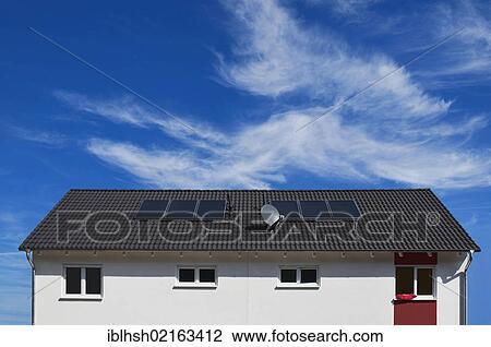 Stock Image - Residential building with solar panels for water heating on the roof, solar heat, Rhein-Erft Kreis district, North Rhine-Westphalia, Germany, Europe, PublicGround, Europe. Fotosearch