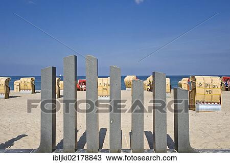 Stock Image - Roofed wicker beach chairs standing on the beach, Dahme, Baltic Sea, Schleswig-Holstein, Germany, Europe. Fotosearch