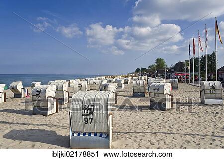 Stock Image - Roofed wicker beach chairs standing on the beach, Dahme, Baltic Sea, Schleswig-Holstein, Germany, Europe. Fotosearch