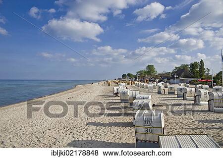 Stock Photo - Roofed wicker beach chairs standing on the beach, Dahme, Baltic Sea, Schleswig-Holstein, Germany, Europe. Fotosearch