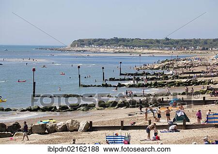 Rows of wooden and rock groynes, sea defences, with red marker poles on Mudeford beach, Mudeford, Dorset, England, United Kingdom, Europe View Large Photo Image Stock Photo - Rows of wooden and rock groynes, sea defences, with red marker poles on Mudeford beach, Mudeford, Dorset, England, United Kingdom, Europe. Fotosearch