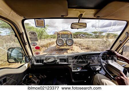 Stock Photo - Safari bus following a Landrover over wet dirt tracks in the Samburu National Reserve, Kenya, East Africa, Africa, PublicGround, Africa. Fotosearch
