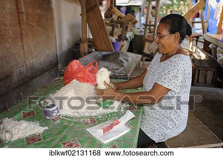 Sago being pressed into a form by a Papuan woman and offered for sale at the fish market in Biak, Kota Biak, Biak Island, Irian Jaya, Indonesia, Southeast Asia, Asia View Large Photo Image Stock Photo - Sago being pressed into a form by a Papuan woman and offered for sale at the fish market in Biak, Kota Biak, Biak Island, Irian Jaya, Indonesia, Southeast Asia, Asia. Fotosearch