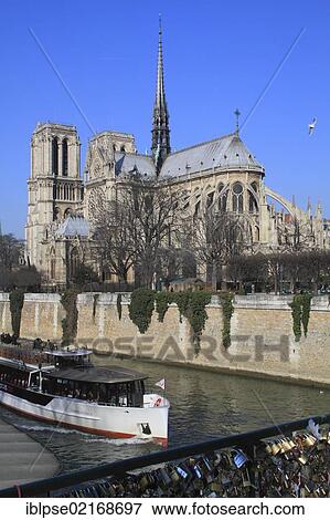 Stock Photo - Seine river with a tourist boat and Notre-Dame Cathedral, from the bridge Pont de l'Archevêché, Paris, France, Europe. Fotosearch