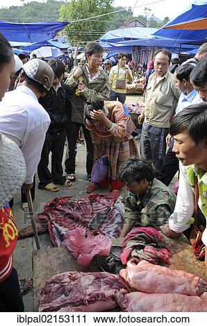 Stock Image - Selling meat at a market, Bac Ha, Vietnam, Southeast Asia, Asia. Fotosearch