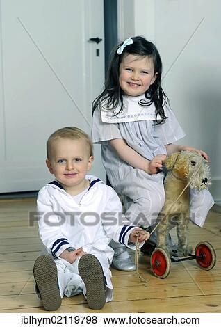 Siblings, boy, 2, and girl, 5, wearing sailor outfits View Large Photo Image Stock Photo - Siblings, boy, 2, and girl, 5, wearing sailor outfits. Fotosearch