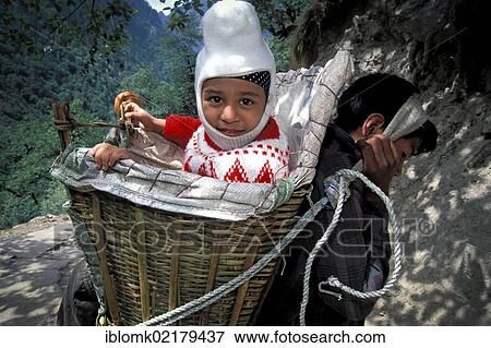 Sikh child in a carrying basket, carrier, near Govindghat, Chamoli district, Uttarakhand, formerly Uttaranchal, Indian Himalayas, North India, India, Asia View Large Photo Image Stock Photo - Sikh child in a carrying basket, carrier, near Govindghat, Chamoli district, Uttarakhand, formerly Uttaranchal, Indian Himalayas, North India, India, Asia. Fotosearch