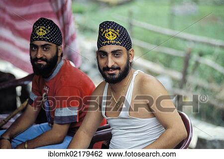 Sikh pilgrims with a Khanda symbol on their hats, near Govindghat, Chamoli district, Uttarakhand, formerly Uttaranchal, Indian Himalayas, North India, India, Asia View Large Photo Image Stock Image - Sikh pilgrims with a Khanda symbol on their hats, near Govindghat, Chamoli district, Uttarakhand, formerly Uttaranchal, Indian Himalayas, North India, India, Asia. Fotosearch