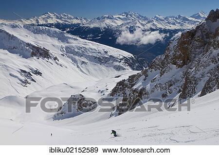 Stock Photo - Skiing downhill with mountain panoramic views, Mt Torrenthorn skiing tour, Leukerbad, Valais, Switzerland, Europe. Fotosearch