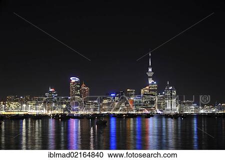 Stock Image - Skyline of Auckland at night, seen from Bayswater, North Island, New Zealand, Oceania. Fotosearch