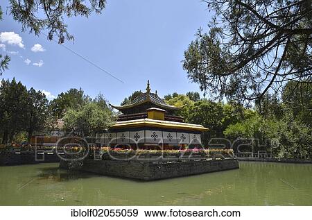 Stock Photo - Small building in the centre of a man-made lake in the summer palace of the Dalai Lama in Norbulingka, jewel garden, Lhasa, Tibet, China, Asia. Fotosearch