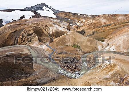 Stock Photography - Small river flowing through the colourful hills and rhyolite mountains of the geothermal area of Kerlingarfjoell Glacier in the interior highlands of Iceland, Europe. Fotosearch