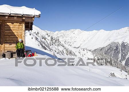 Snowshoer resting at Jagelealm alpine pasture above Entholz, overlooking the Ridnauntal Valley, Alto Adige, Italy, Europe View Large Photo Image Stock Photo - Snowshoer resting at Jagelealm alpine pasture above Entholz, overlooking the Ridnauntal Valley, Alto Adige, Italy, Europe. Fotosearch