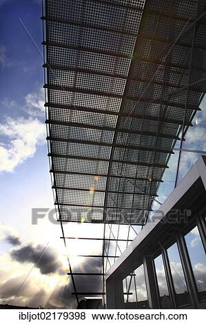 Stock Photo - Solar roof in Messe Essen Exhibition Centre, roof of the connecting corridor between the exhibition halls in the west-wing covered with solar panels, glass art work by art professor Joerg Immendorff, Essen, North Rhine-Westphalia, Germany, Europe. Fotosearch