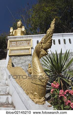 Standing Buddha statue at a temple on Phousi Mountain, Luang Prabang, Laos, Indochina, Asia View Large Photo Image Stock Image - Standing Buddha statue at a temple on Phousi Mountain, Luang Prabang, Laos, Indochina, Asia. Fotosearch