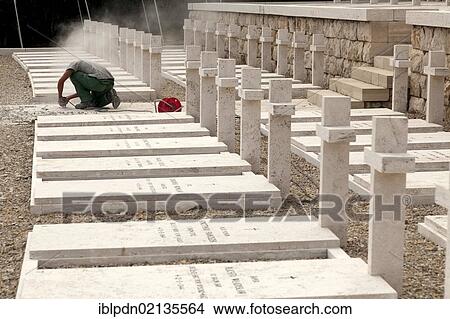 Picture - Stone mason working on gravestones at the Polish Cemetery, Monte Cassino, Lazio, Italy, Europe. Fotosearch