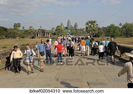 Stock Image - Stream of visitors on the stone dam leading to Angkor Wat, Siam Reap, Cambodia, Southeast Asia, Asia. Fotosearch