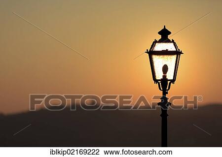 Street lamp silhouetted against the rising sun, Torrechiara, Italy, Europe View Large Photo Image Stock Image - Street lamp silhouetted against the rising sun, Torrechiara, Italy, Europe. Fotosearch