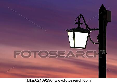 Street lamp silhouetted against the setting sun in Venice, Italy, Europe View Large Photo Image Stock Photograph - Street lamp silhouetted against the setting sun in Venice, Italy, Europe. Fotosearch