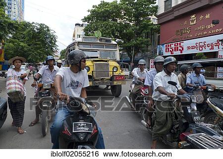 Street scene, Burmese men riding mopeds or scooters, pedestrians, old Burmese bus on the road to the market in Mandalay, Burma, Myanmar, Southeast Asia, Asia View Large Photo Image Stock Photograph - Street scene, Burmese men riding mopeds or scooters, pedestrians, old Burmese bus on the road to the market in Mandalay, Burma, Myanmar, Southeast Asia, Asia. Fotosearch