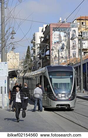 Street scene on the Jaffa Road with Orthodox Jews and a tram of the new tram line, light rail, and a mural of the new tram on a wall, Jerusalem, Israel, Middle East, Southwest Asia, Asia View Large Photo Image Stock Image - Street scene on the Jaffa Road with Orthodox Jews and a tram of the new tram line, light rail, and a mural of the new tram on a wall, Jerusalem, Israel, Middle East, Southwest Asia, Asia. Fotosearch