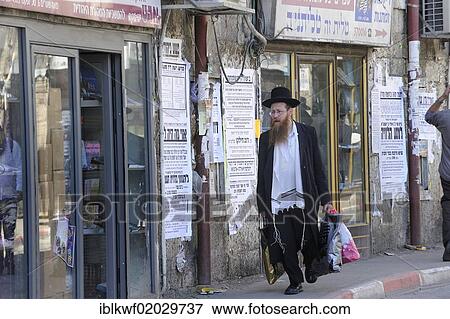 Street scene with an Orthodox Jew in the Me'a She'arim district, with typical houses and wall newspapers, Jerusalem, Israel, Middle East, Asia View Large Photo Image Stock Photo - Street scene with an Orthodox Jew in the Me'a She'arim district, with typical houses and wall newspapers, Jerusalem, Israel, Middle East, Asia. Fotosearch
