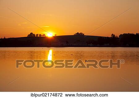 Stock Image - Sunrise at Grosshartmannsdorfer Teich pond, conservation area, Erzgebirge, Ore Mountains, Saxony, Germany, Europe. Fotosearch