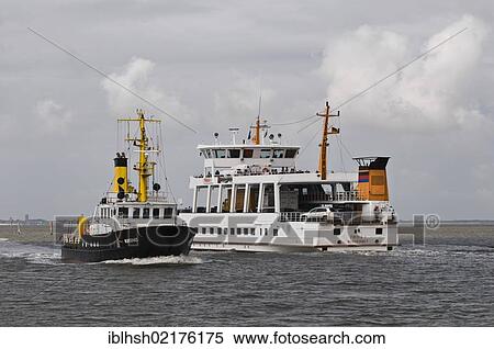 Stock Photography - Survey ship "Norderney" and ferry "Frisia 1" at the exit of the port of Norddeich, Wadden Sea UNESCO World Heritage Site, Lower Saxony, North Sea, Germany, Europe. Fotosearch