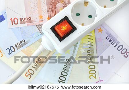 Stock Photography - Switchable multi-plug extension lead, euro banknotes, symbolic image for energy costs, electricity costs, energy savings. Fotosearch
