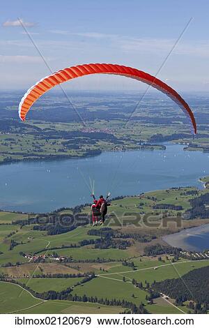 Tandem paragliders overlooking Froggensee lake, Tegelberg Mountain, Upper Bavaria, Bavaria, Germany, Europe, PublicGround, Europe View Large Photo Image Stock Photo - Tandem paragliders overlooking Froggensee lake, Tegelberg Mountain, Upper Bavaria, Bavaria, Germany, Europe, PublicGround, Europe. Fotosearch