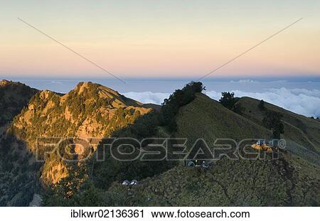 Stock Image - Tents at sunrise on the rim of the Rinjani Volcano, Lombok, Indonesia, Asia. Fotosearch
