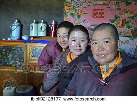 Three Tibetan nuns sitting in the kitchen of the nunnery in front of thermos flasks for the butter tea, in the mountains of Reting Monastery, Mount Gangi Rarwa, Himalayas, Lhundrup Country, Central Tibet, Tibet, Asia View Large Photo Image Stock Photo - Three Tibetan nuns sitting in the kitchen of the nunnery in front of thermos flasks for the butter tea, in the mountains of Reting Monastery, Mount Gangi Rarwa, Himalayas, Lhundrup Country, Central Tibet, Tibet, Asia. Fotosearch