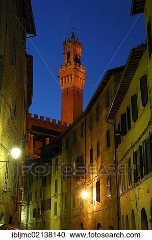 Stock Image - Torre del Mangia tower at dusk, Siena, Tuscany, Italy, Europe. Fotosearch