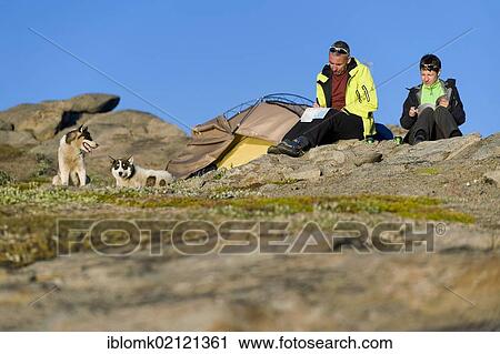 Tourists in front of tent and free-running huskies, Tasiilaq or Ammassalik, East Greenland View Large Photo Image Stock Image - Tourists in front of tent and free-running huskies, Tasiilaq or Ammassalik, East Greenland. Fotosearch