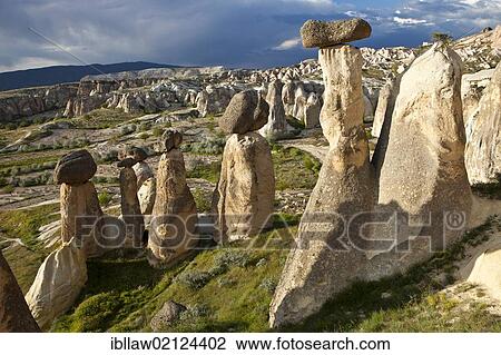 Tufa Fairy Chimneys with basalt blocks placed on top, rock formations at Cavushin, Goreme, UNESCO World Heritage Site, Cappadocia, Anatolia, Turkey, Asia View Large Photo Image Stock Image - Tufa Fairy Chimneys with basalt blocks placed on top, rock formations at Cavushin, Goreme, UNESCO World Heritage Site, Cappadocia, Anatolia, Turkey, Asia. Fotosearch