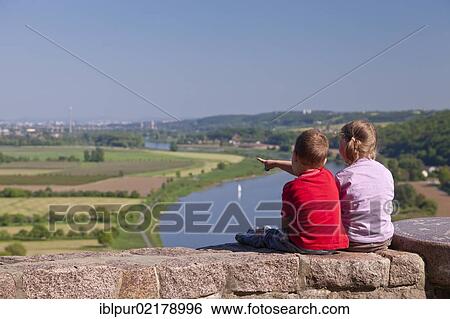 Stock Photograph - Two children looking from Boselspitze Mountain into the Elbe Valley with the Elbe River, Soernewitz, Brockwitz and Coswig, Saxony, Germany, Europe. Fotosearch