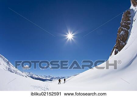 Stock Image - Two mountaineers on ascent with skis, Mt Torrenthorn skiing tour, Leukerbad, Valais, Switzerland, Europe. Fotosearch