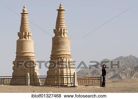 Two Stupa with a man looking towards the Gobi Desert, Mogao Grottoes near Dunhuang, Silk Road, Gansu, China, Asia View Large Photo Image Stock Photo - Two Stupa with a man looking towards the Gobi Desert, Mogao Grottoes near Dunhuang, Silk Road, Gansu, China, Asia. Fotosearch