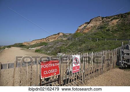 Under cliff path closed sign and fencing due to ground movement and sea erosion at Barton on Sea, Hampshire, England, United Kingdom, Europe View Large Photo Image Stock Photo - Under cliff path closed sign and fencing due to ground movement and sea erosion at Barton on Sea, Hampshire, England, United Kingdom, Europe. Fotosearch