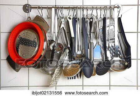 Various kitchen tools and utensils, hanging on a wall in a kitchen View Large Photo Image Stock Photograph - Various kitchen tools and utensils, hanging on a wall in a kitchen. Fotosearch