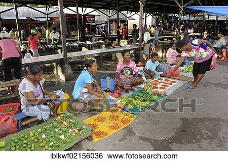 Stock Photograph - Vegetable sellers sitting on the ground selling betel nuts and chili peppers, Kota Biak, Biak Island, Irian Jaya, Indonesia Southeast Asia, Asia. Fotosearch