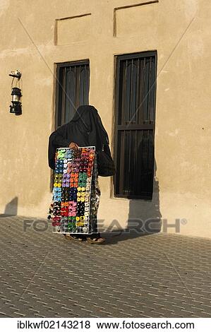 Veiled Arabian woman carrying embroidery yarn, Al Schindagha, Dubai, United Arab Emirates, Arabian Peninsula, Middle East, Asia View Large Photo Image Stock Photo - Veiled Arabian woman carrying embroidery yarn, Al Schindagha, Dubai, United Arab Emirates, Arabian Peninsula, Middle East, Asia. Fotosearch